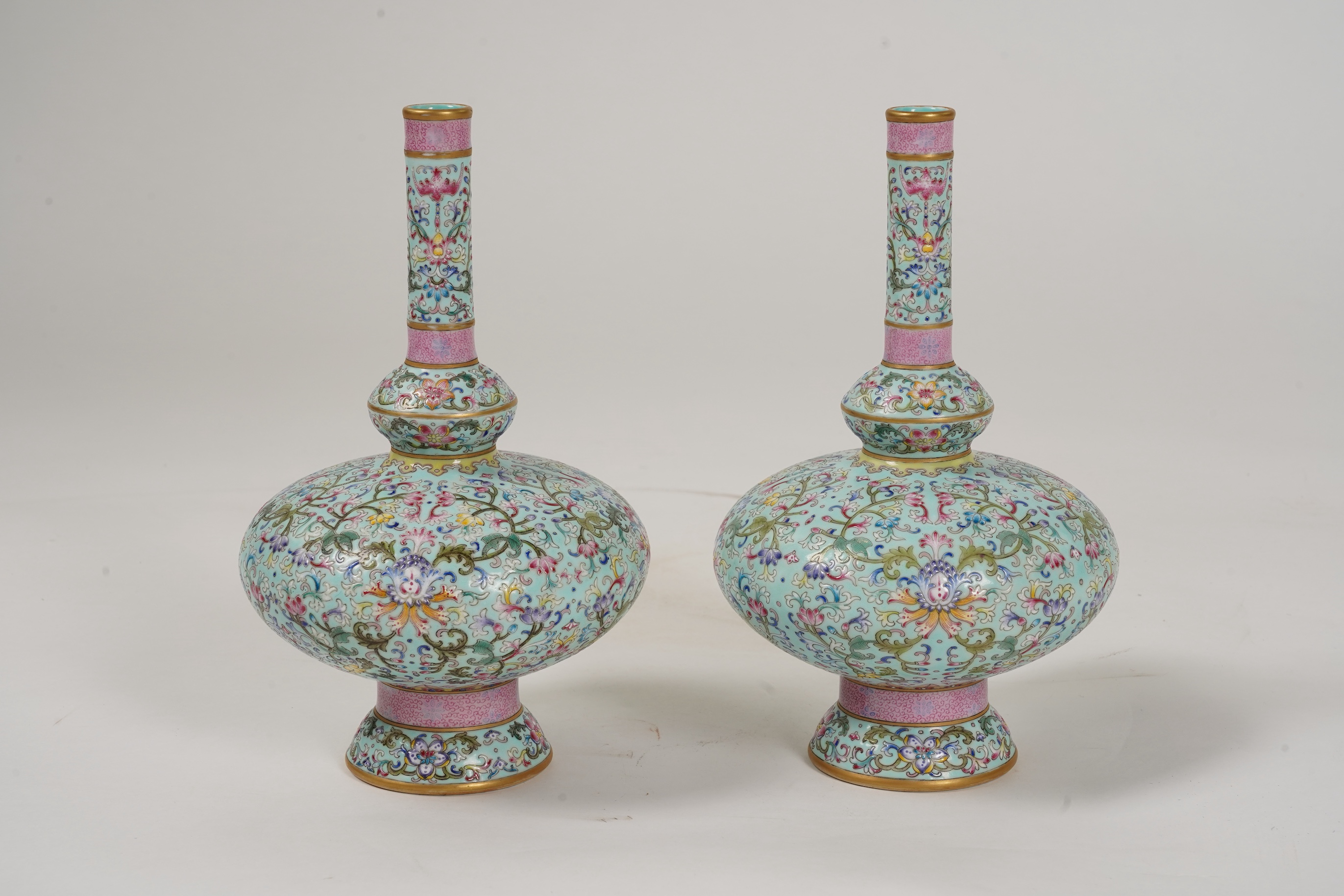 A pair of Chinese famille rose enamelled porcelain bottle vases, Qianlong seal mark to base but Republic Period
